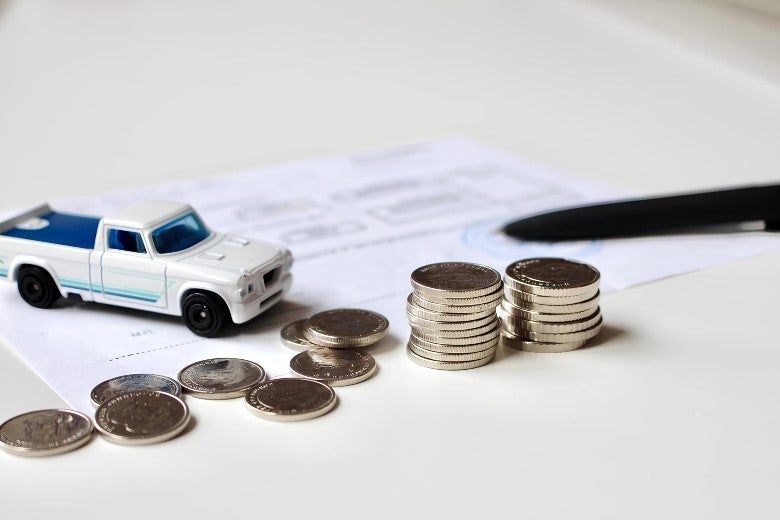 Stack of coins with a toy truck